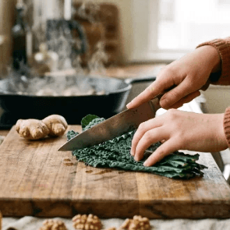 Hands preparing food in a kitchen